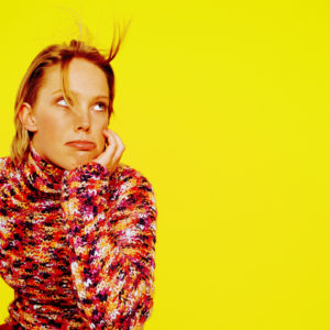 Woman Sitting with a Bored Expression